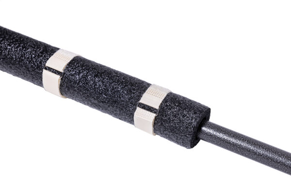 A close-up of a black foam pipe insulation tube secured with two SPEEDWRAP® High Temp Cinch Straps, wrapped around a metal pipe on a white background.