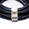 A black cable is neatly coiled and secured with a beige SPEEDWRAP® High Temp Cinch Strap against a white background.