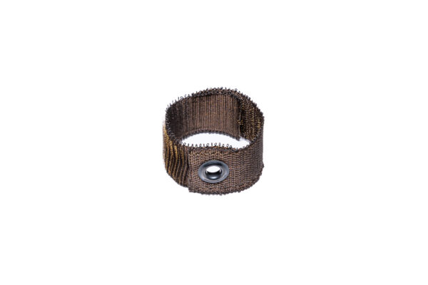KVNR6811 - Speedtech International A SPEEDWRAP® Stainless Steel Hook & Loop Banding Tie, cylindrical with a fine metallic mesh and central grommet, is shown standing upright on a white background.
