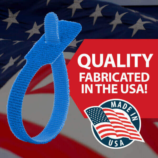 A blue hook-and-loop cable tie in front of an American flag background. Text reads QUALITY FABRICATED IN THE USA! with a Made in USA badge featuring a waving flag.