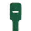 Close-up of the end of a green plastic cable tie, showing a rectangular hole and textured surface.