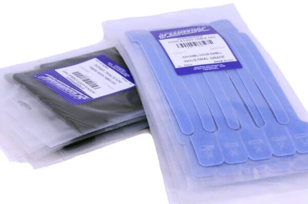 Two vacuum-sealed packs of blue and black Flowmark industrial cable ties, with product labels visible on the packaging.
