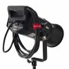 A professional studio light with controls and ports visible on the back, a coiled power cable secured with a red strap, and mounted on a black stand against a white background.