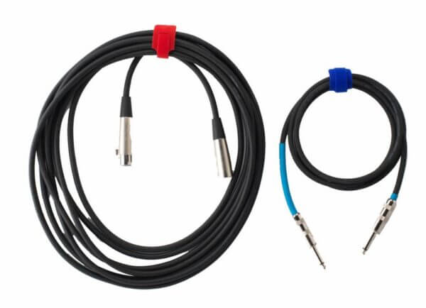 Two coiled audio cables are shown on a white background. The left cable, with a red strap, has XLR connectors. The right cable, with a blue strap, has 1/4-inch TS connectors and blue heat shrink on one end.