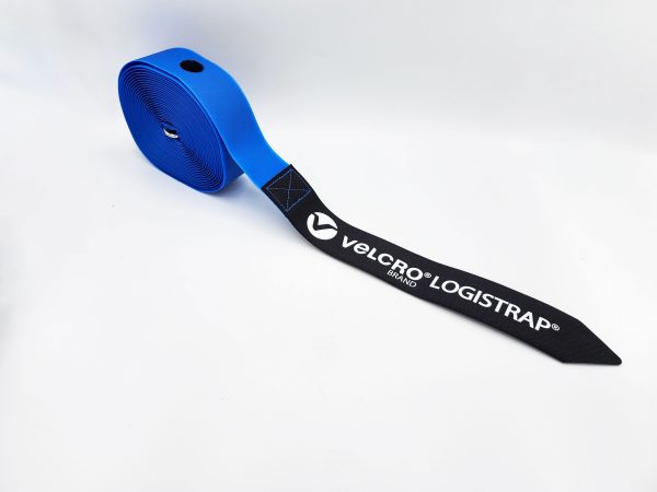 A coiled blue strap with a black pointed end, labeled "VELCRO® Brand LOGISTRAP® Pallet Straps," shown on a white background.