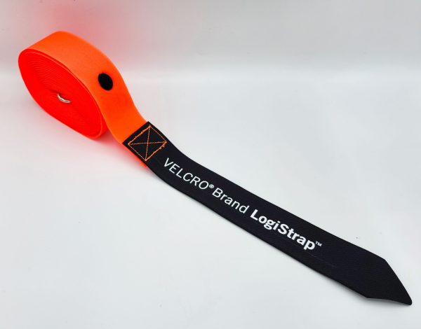 A rolled-up orange VELCRO® Brand LOGISTRAP® Pallet Strap with a black end labeled in white text, shown on a plain white surface.