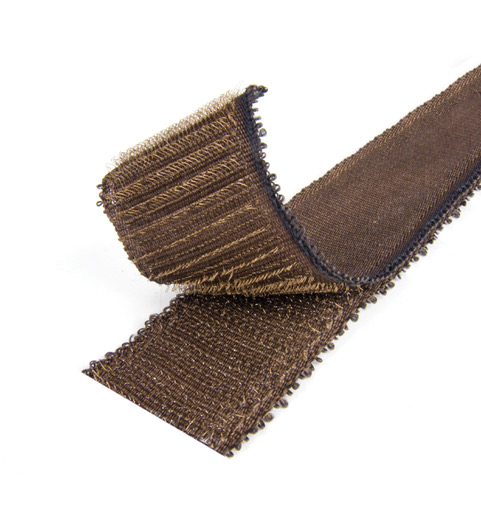 A close-up of a VELCRO® Brand HI-GARDE® Fastener strip shows its brown, rough-textured industrial material with finished black edges, partially curled upward at one end.